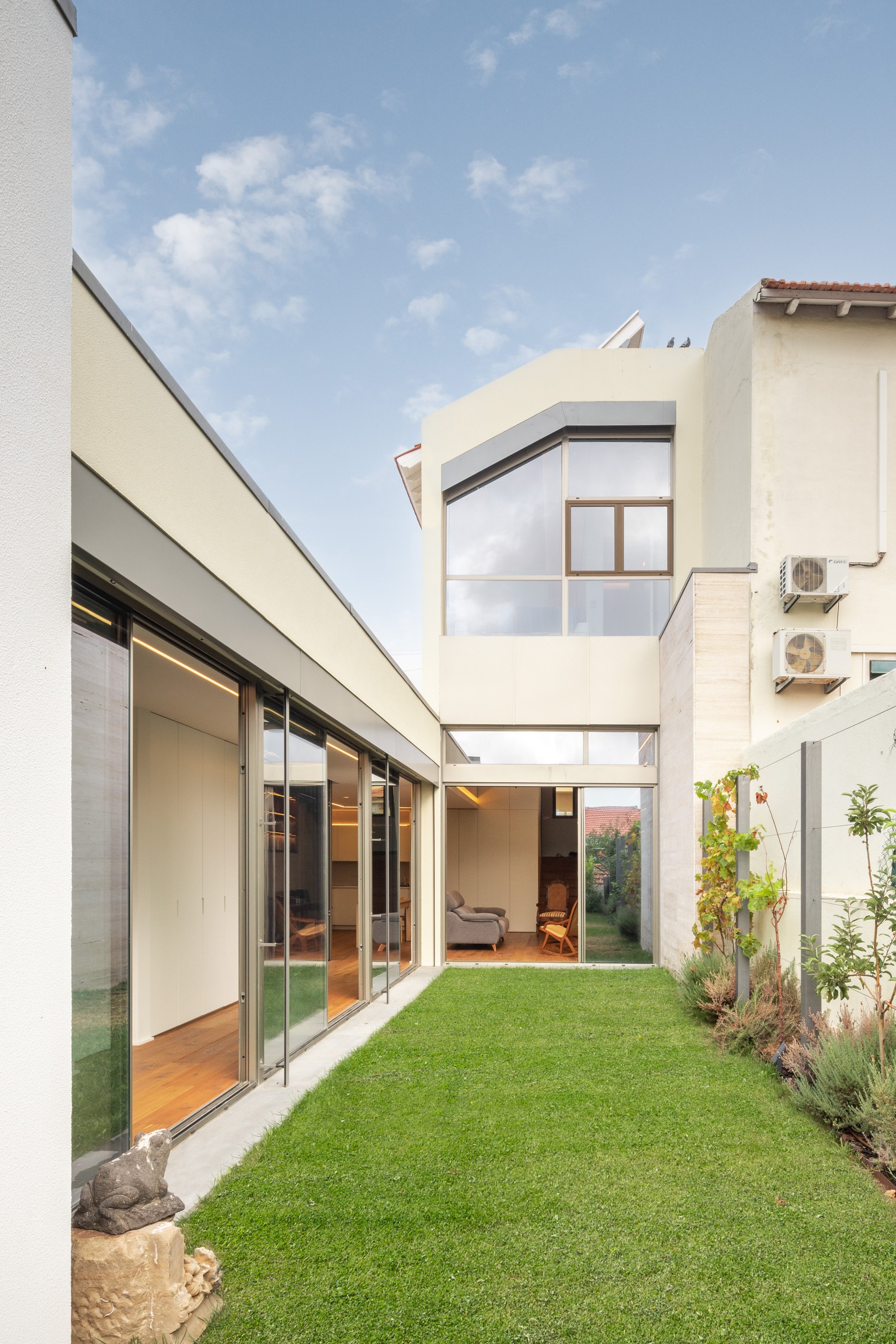 Empty Space Architecture Carves Courtyards Through a Lisbon House to Pull the Garden Inside