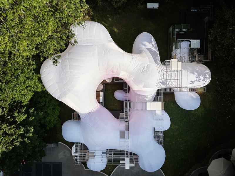 Aerial view of the white inflated membrane roof with bulbous lobes nestled among surrounding trees and buildings