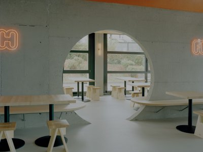 Noue Studio Organizes a Swiss Restaurant Around a Single Concrete Wall