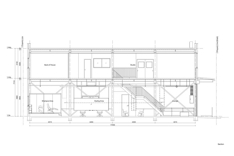 Section drawing showing two-story interior with central staircase connecting shampoo area below to back of house above