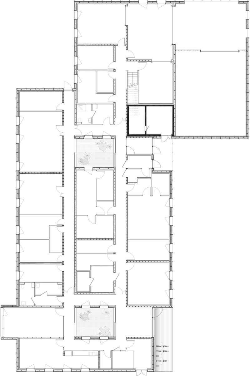 Floor plan drawing depicting multiple rooms and circulation spaces arranged around a central stairwell