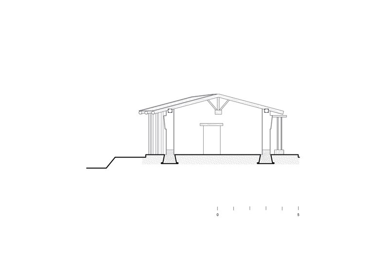 Section drawing showing gabled roof structure with central truss and columns on hatched foundation