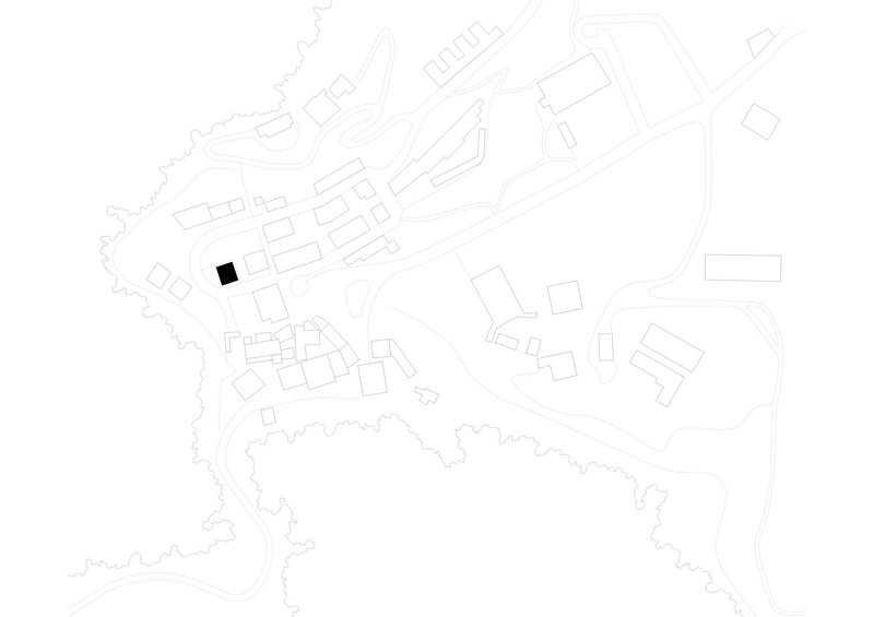 Site plan drawing showing a single building footprint highlighted in black within a hillside village layout