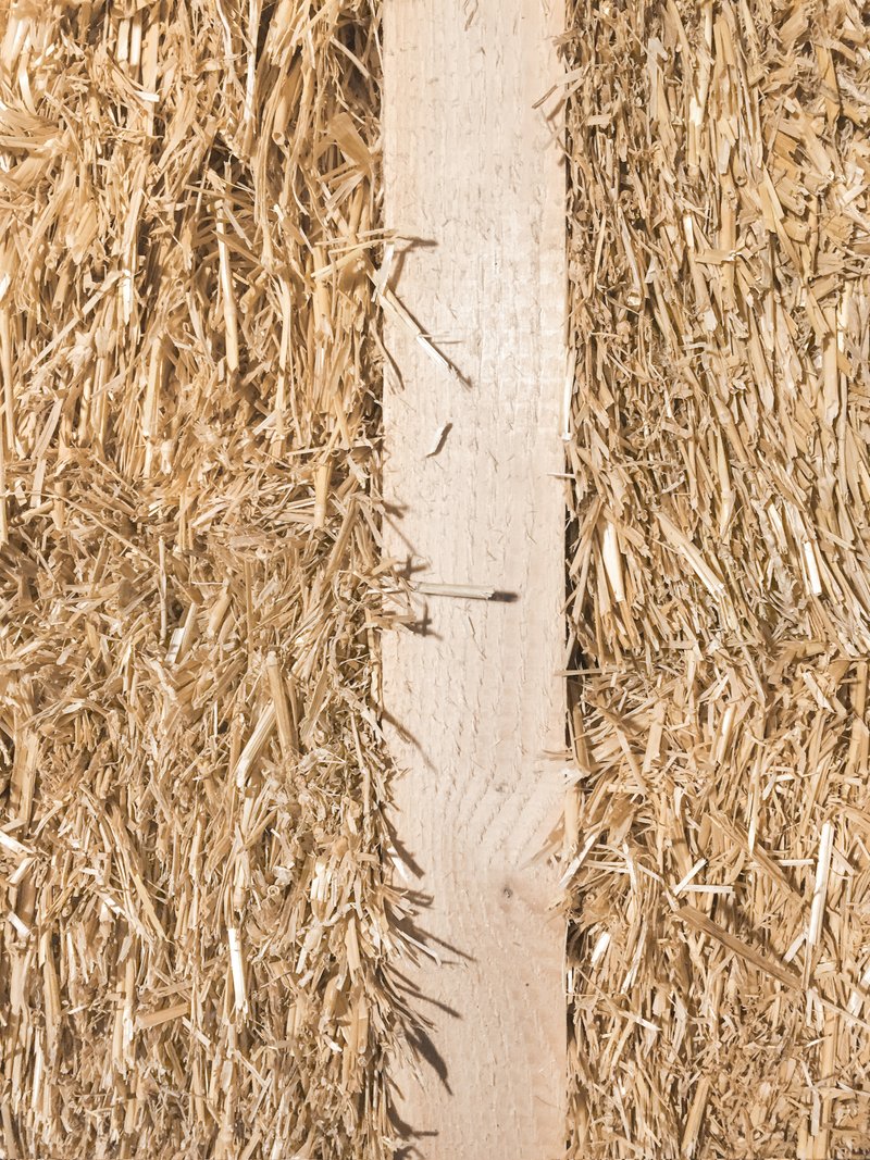 Detail of straw insulation panels meeting a vertical timber structural element