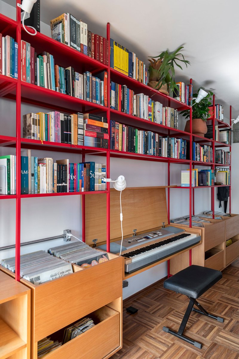 Red steel shelving unit with pull-out keyboard drawer and timber storage compartments below