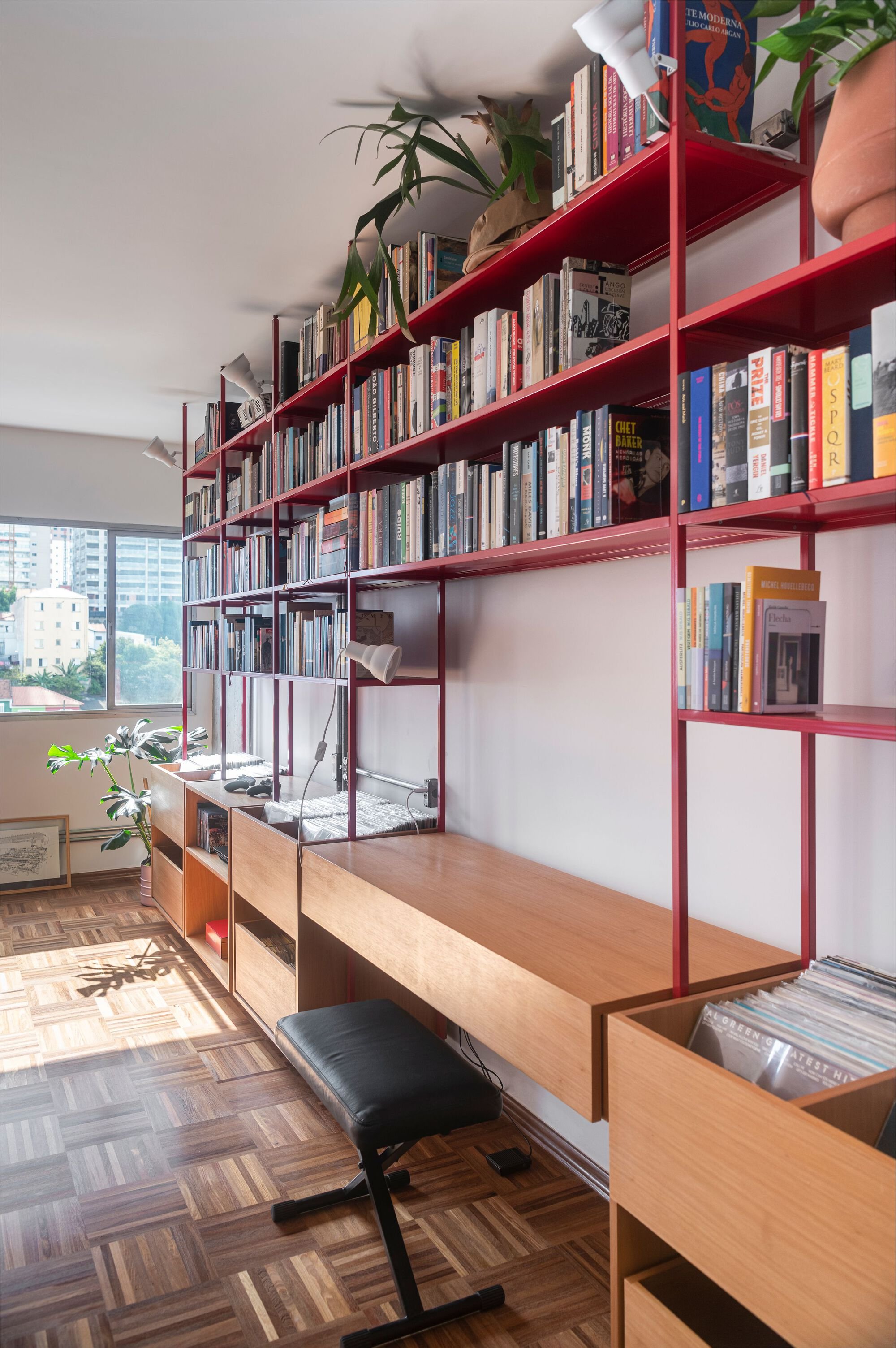 COTA760 Wraps a São Paulo Apartment in a Continuous Red Steel Bookshelf