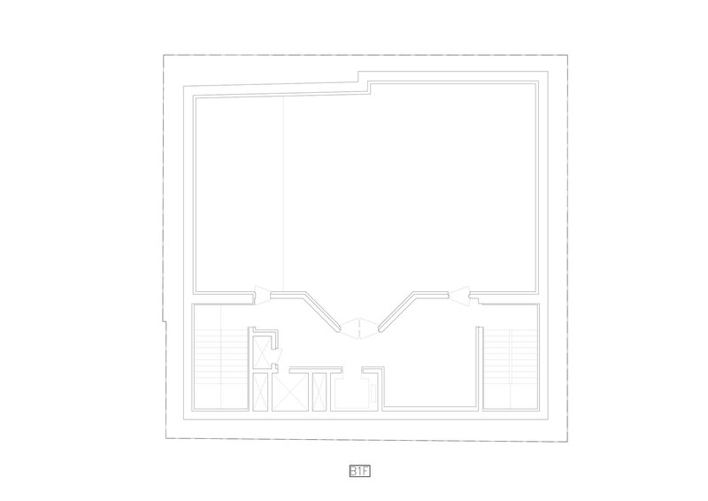 Floor plan drawing showing a large open room with two staircases and central service spaces below
