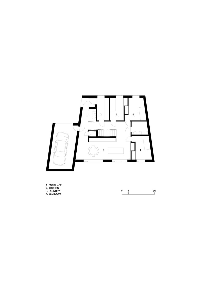 Floor plan drawing showing ground level with angled garage, kitchen and bedroom spaces