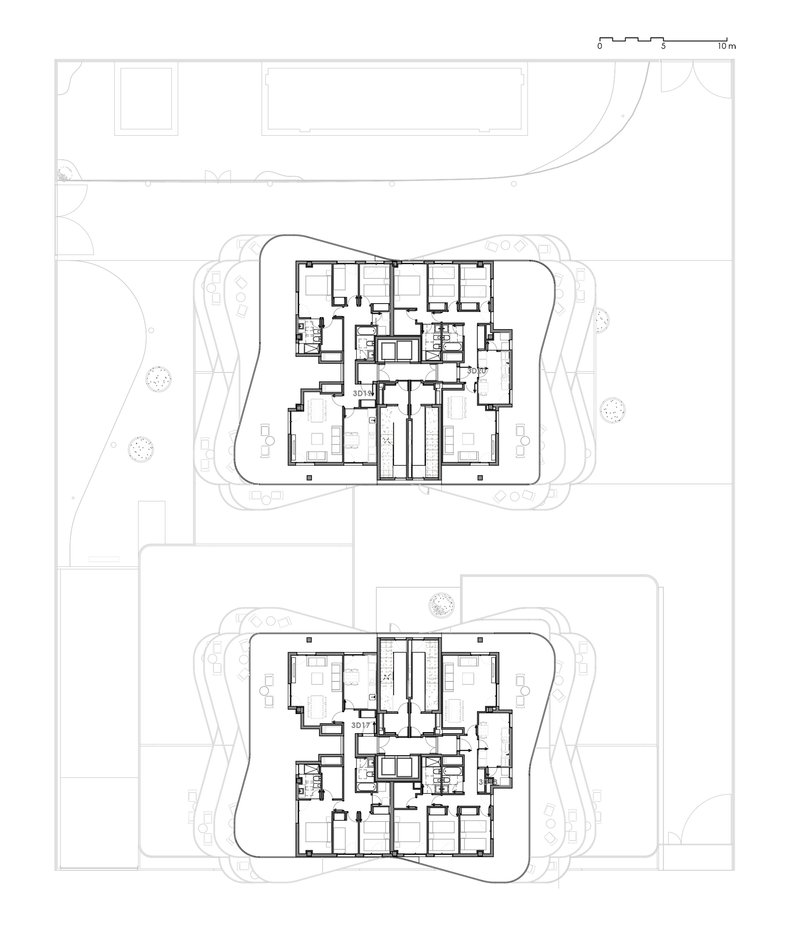 Floor plan drawings showing two levels with central circulation cores and residential units around curved building edges