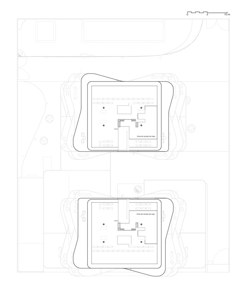 Floor plan drawings showing two basement levels with parking and service zones within rounded building footprints