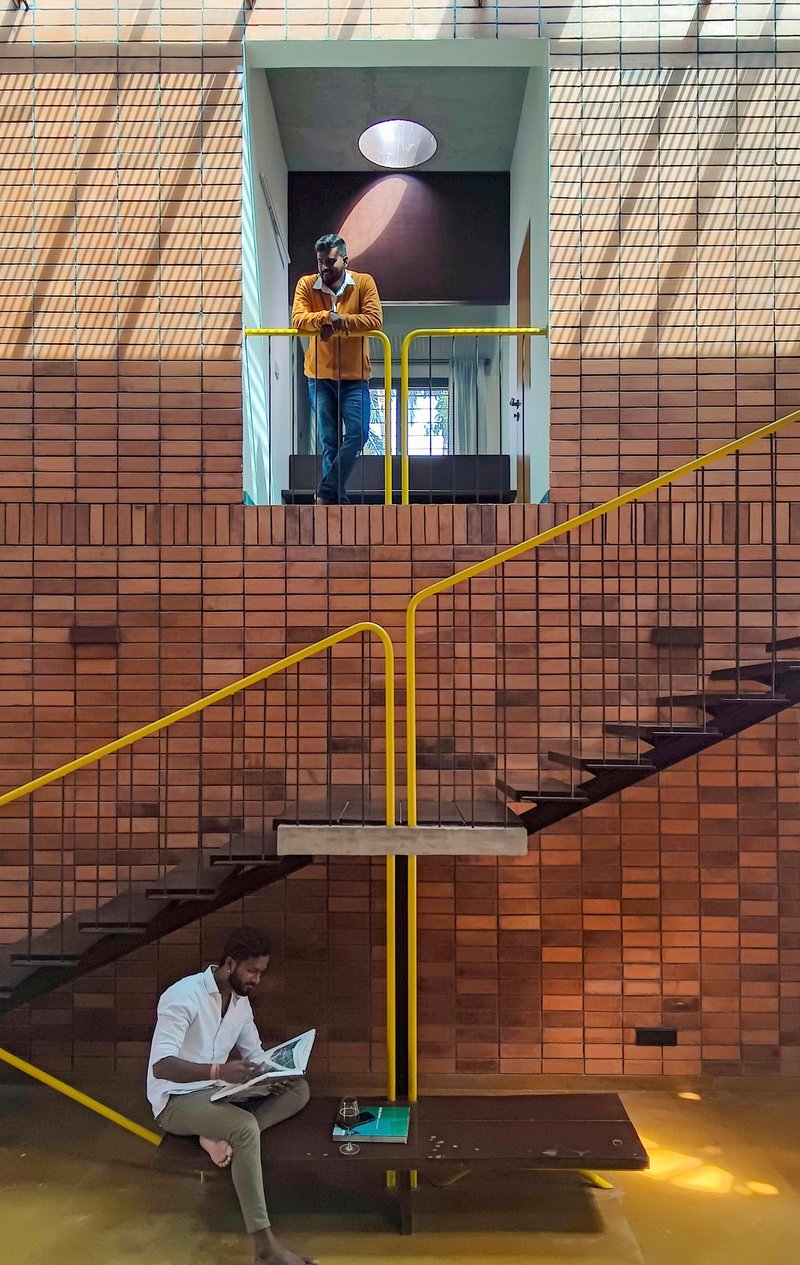 Stairwell crossing the double-height space with two people using the different levels