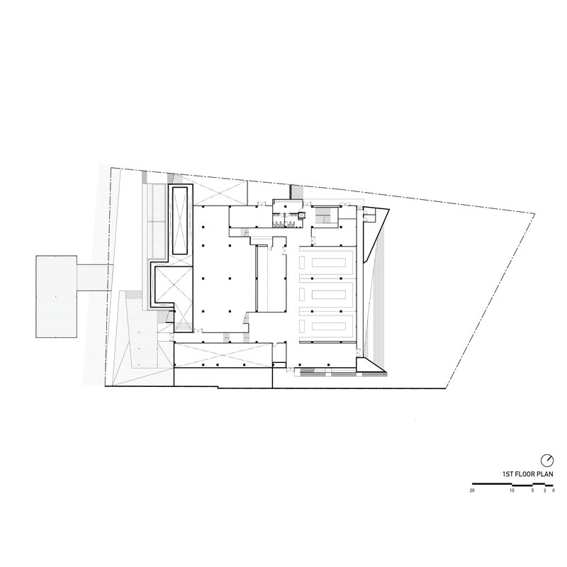 First floor plan drawing showing trapezoid site with central courtyard and perimeter support spaces