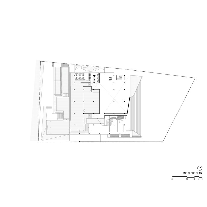 Second floor plan drawing showing open gallery spaces and service cores within trapezoid footprint