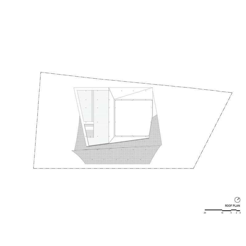 Roof plan drawing showing angular rooflines and hatched ground area within the trapezoidal site