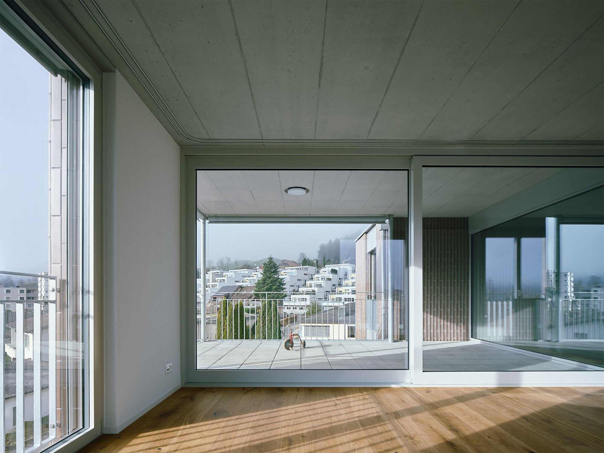 dolmus Architekten Wraps a Willisau Apartment Block in Curved Tiles and Galvanised Steel