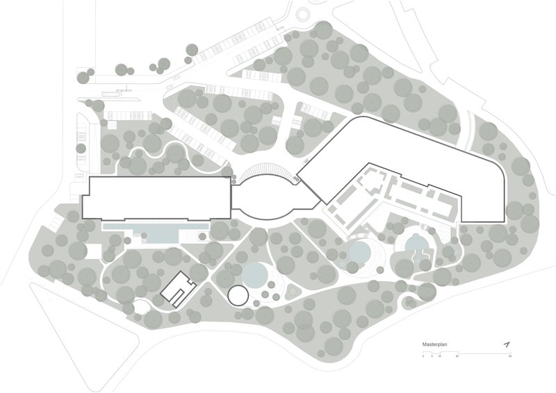 Site plan drawing showing building footprints surrounded by tree canopies and landscaped pathways