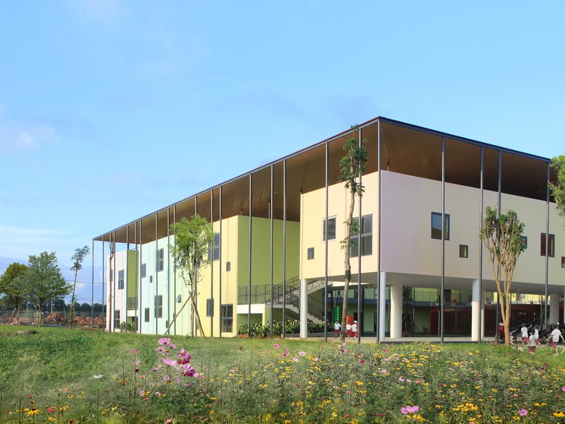 Side elevation showing thin canopy over colored panels with wildflowers in foreground