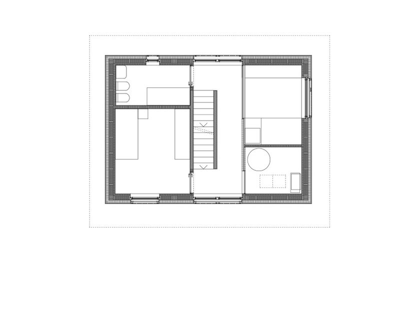 Ground floor plan showing two rooms, bathroom with circular tub, central stair, and thick exterior walls