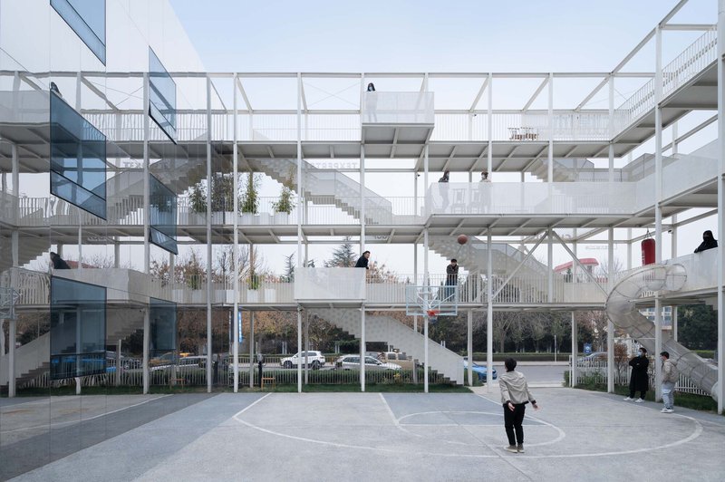 Central courtyard with exposed structural grid connecting multi-level residential units and circulation stairs