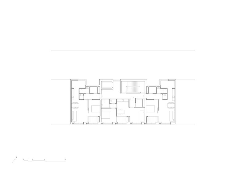 Upper floor plan drawing with symmetrical residential units flanking a central stair core