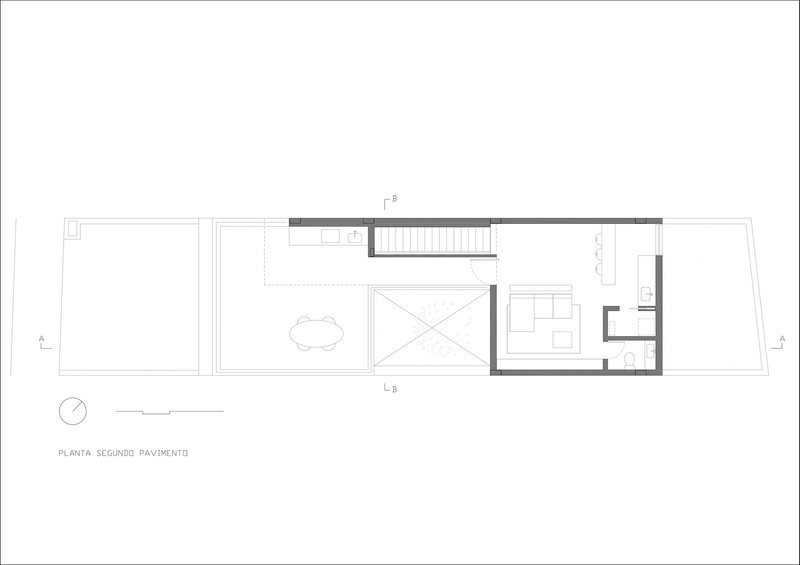 Second floor plan drawing showing a central courtyard with a tree alongside stair and service rooms