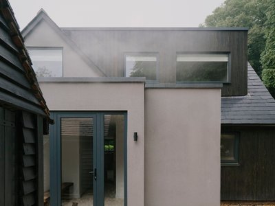 MiMStudios Wraps a 1968 Surrey Hills Home in Dark Timber and Permaculture Gardens