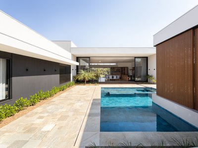 Raul Gobetti Frames a Native Forest in Ourinhos with Two Terracotta Volumes and a Central Courtyard