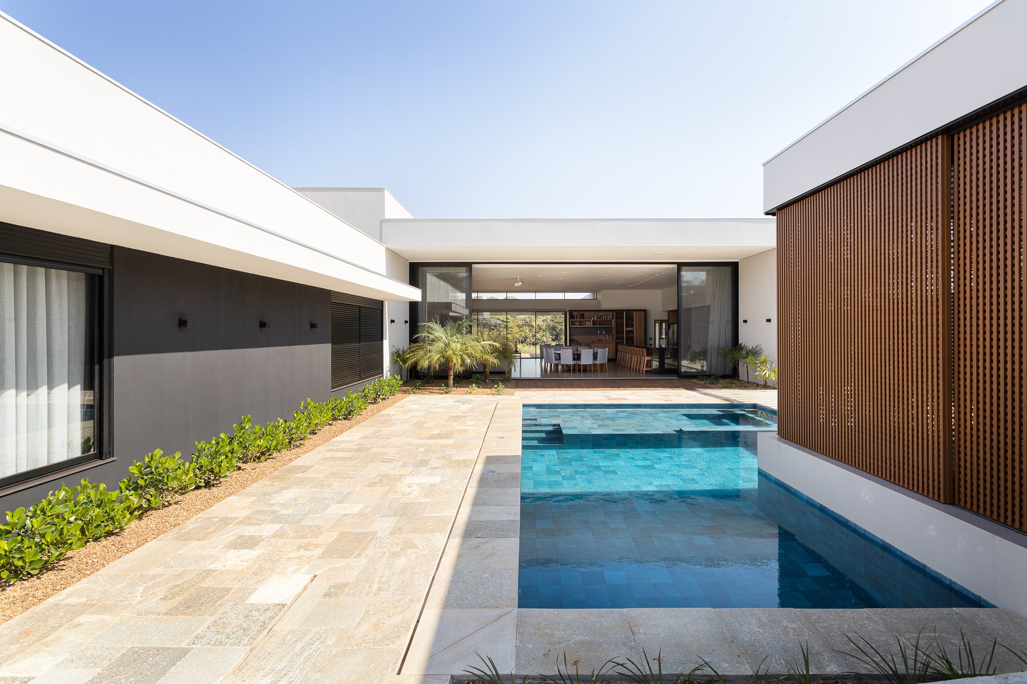 Raul Gobetti Frames a Native Forest in Ourinhos with Two Terracotta Volumes and a Central Courtyard