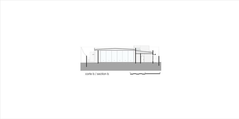 Section drawing revealing interior volumes with sloped roof and vertical slat screen