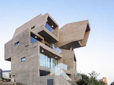 Moon Hoon Stacks Eight Concrete Boxes into a Wave-Shaped House on Jeju Island