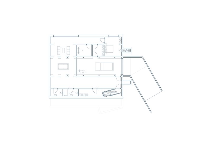 Floor plan drawing showing living spaces with angled wing and central circulation