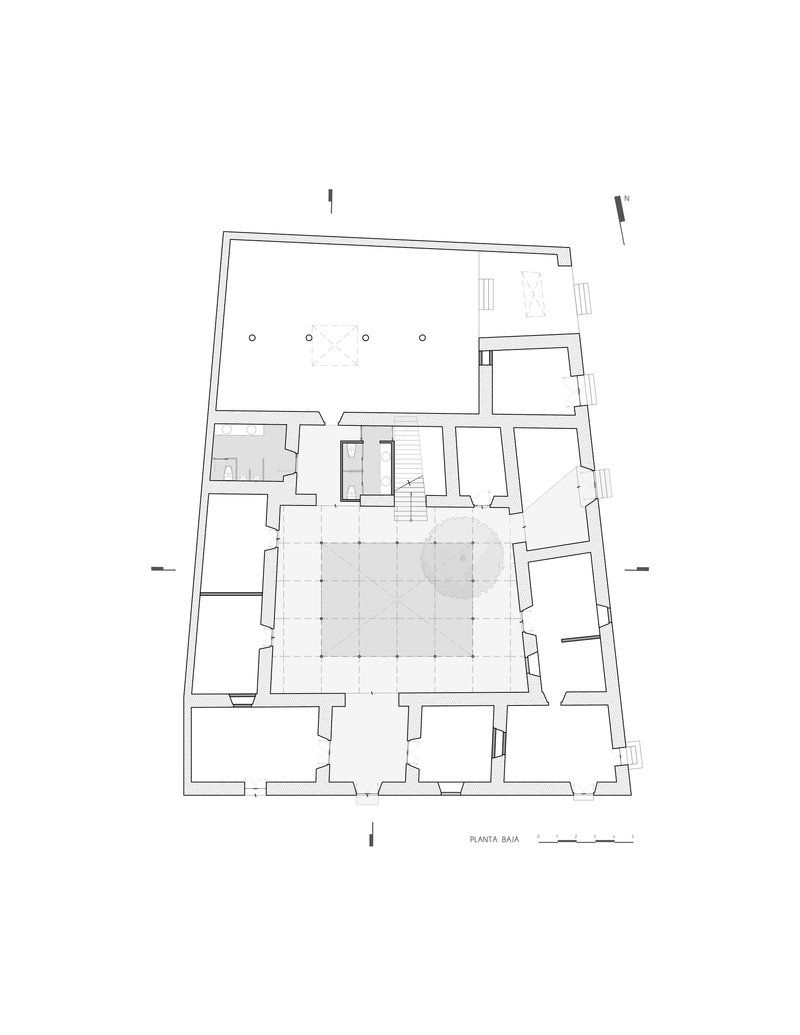 Ground floor plan drawing showing a large courtyard surrounded by perimeter rooms and a central stair