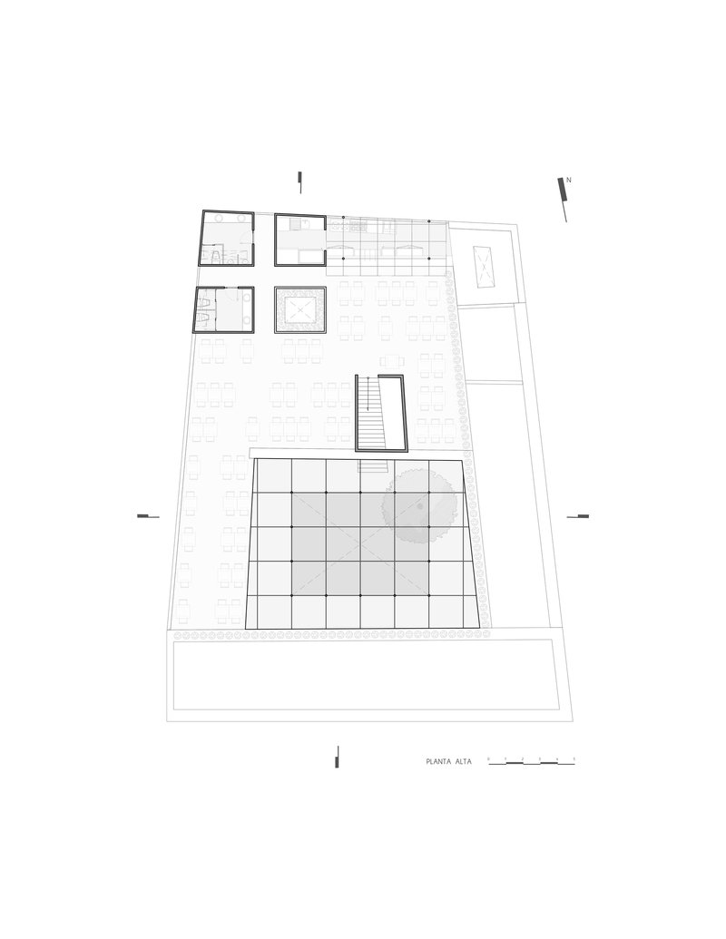 Upper floor plan drawing showing an open terrace with gridded paving and enclosed service rooms