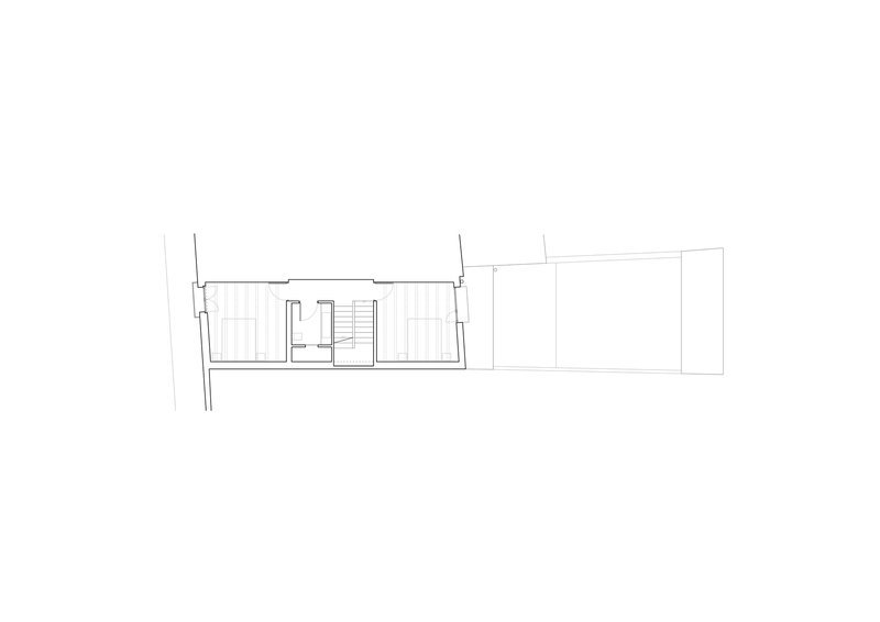 Section drawing showing a narrow two-story interior with central staircase and adjacent structure