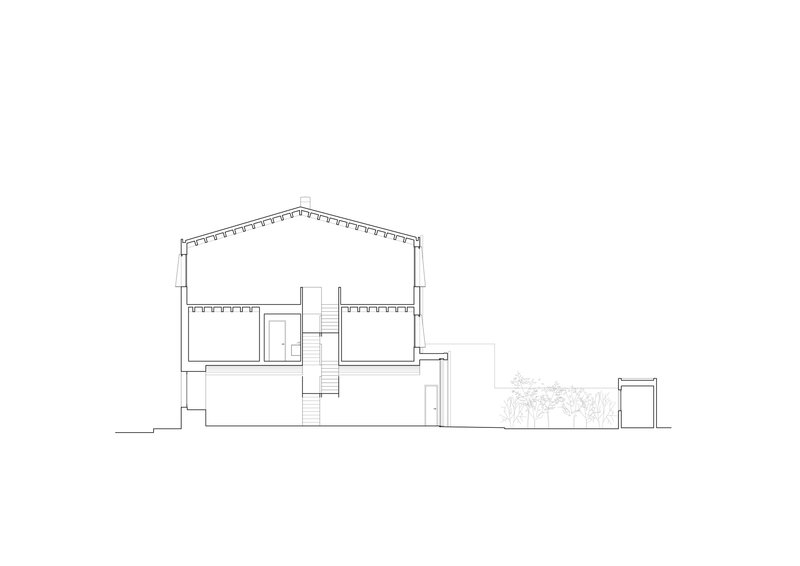 Section drawing revealing a pitched roof structure with exposed joists and split-level interior spaces