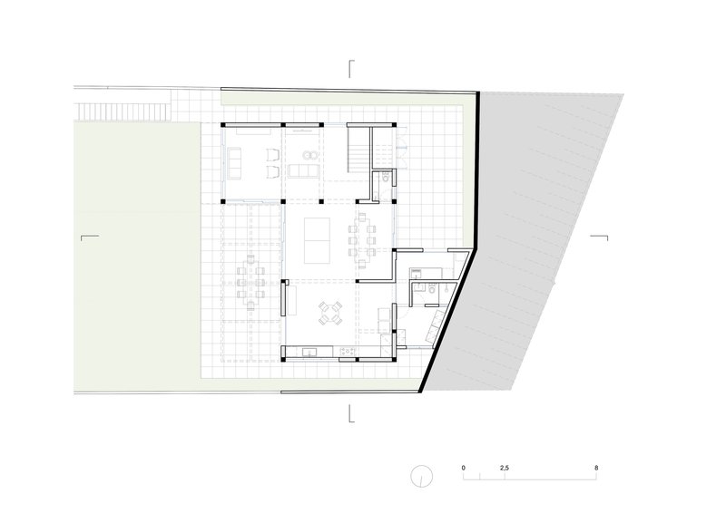 Floor plan drawing showing open living area with gridded terrace and angled street edge