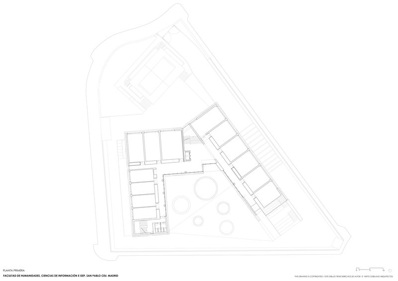 First floor plan drawing showing circular elements in the courtyard connecting two angled building volumes