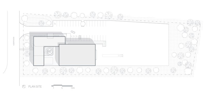 Site plan drawing showing two offset rectangular volumes surrounded by landscaping and tree placements