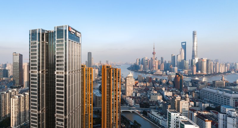 Aerial view of twin striped towers rising above the urban skyline at dusk
