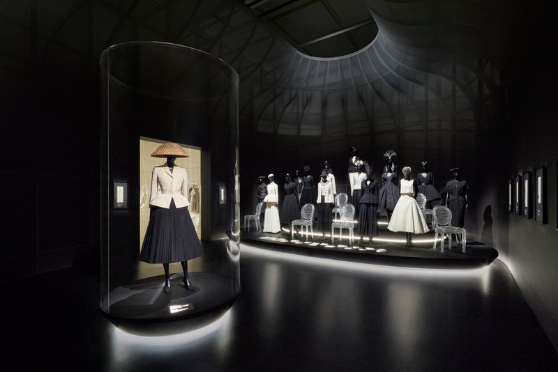 Cylindrical display vitrine with spot lighting in a dark circular gallery space
