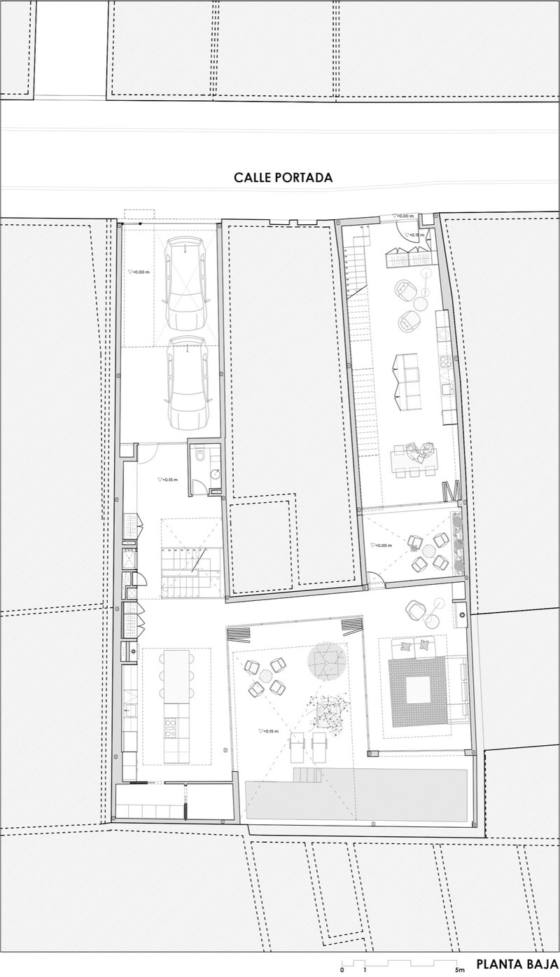 Ground floor plan drawing showing garage spaces, courtyard, and living areas with furniture layout