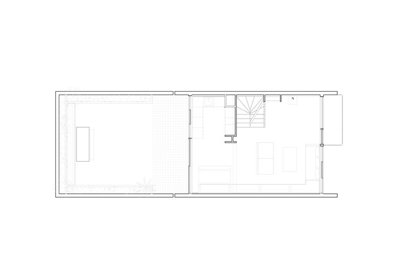 Floor plan drawing displaying two rectangular rooms with central stair and furniture outlines