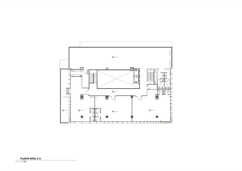 Floor plan drawing showing a large central hall surrounded by smaller rooms with multiple stair cores