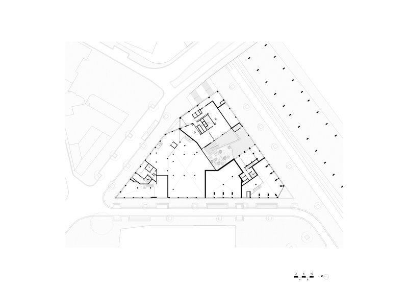 Ground floor plan drawing showing the triangular building with central courtyard and perimeter circulation spaces