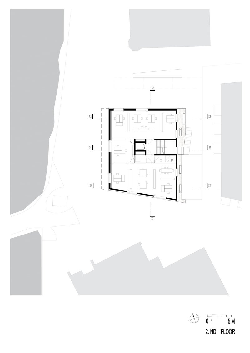 Second floor plan showing open living spaces and central stairwell with surrounding terraces