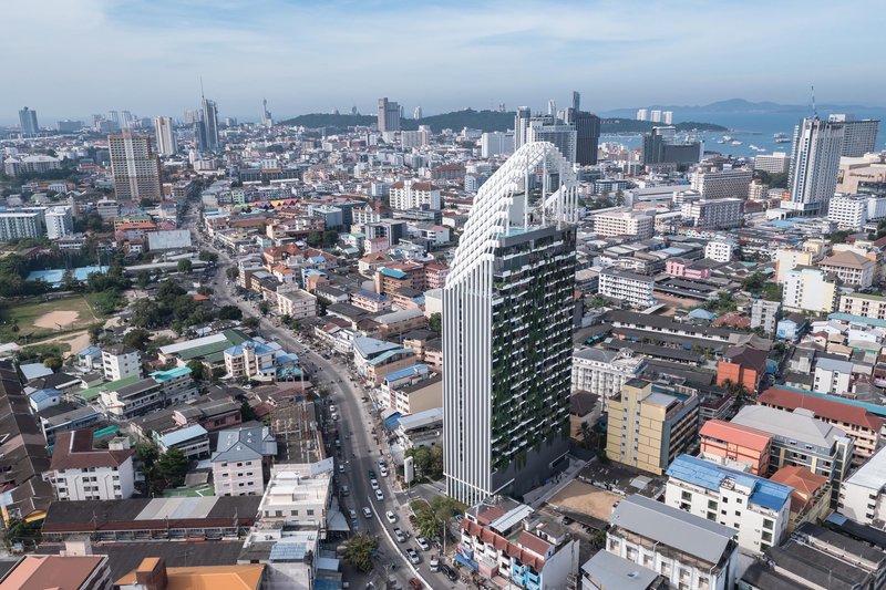 Aerial view of the tower rising above surrounding low-rise urban fabric with the bay in the distance