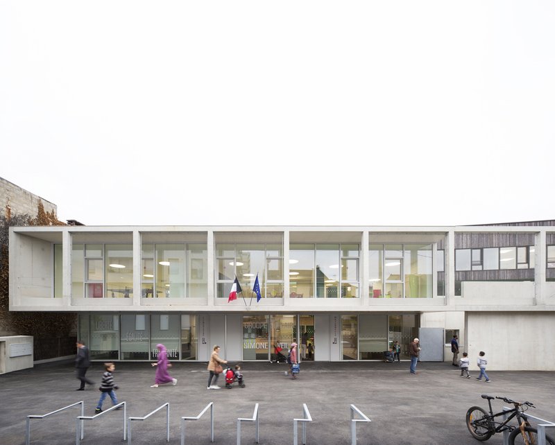 Street-facing elevation showing two-storey glazed volume with white frame and children in motion