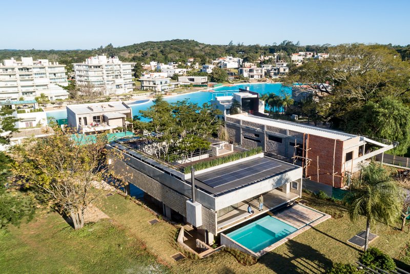 Aerial view of the layered roof planes with solar panels and rooftop garden beds