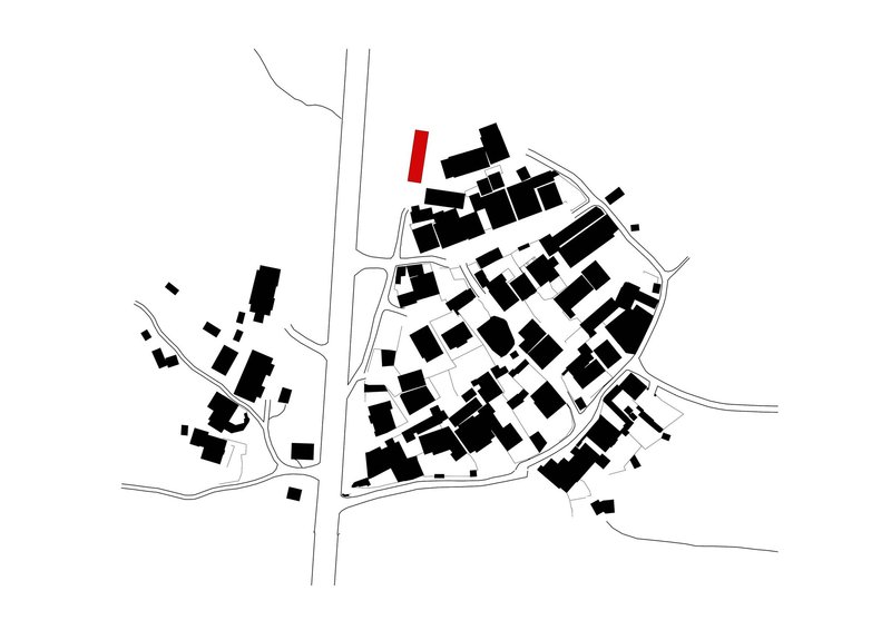 Site plan drawing showing building footprints in black with one highlighted in red