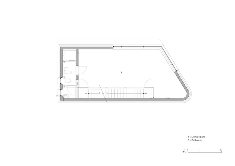 First floor plan drawing showing living room and bathroom with a central staircase